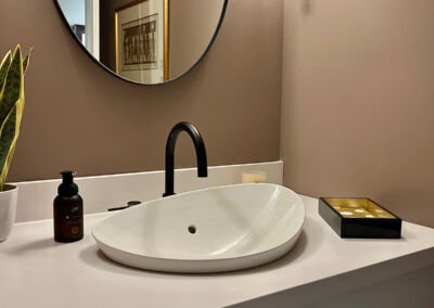 Custom bathroom vanity with vessel sink and round mirror, Kali Custom Cabinetry