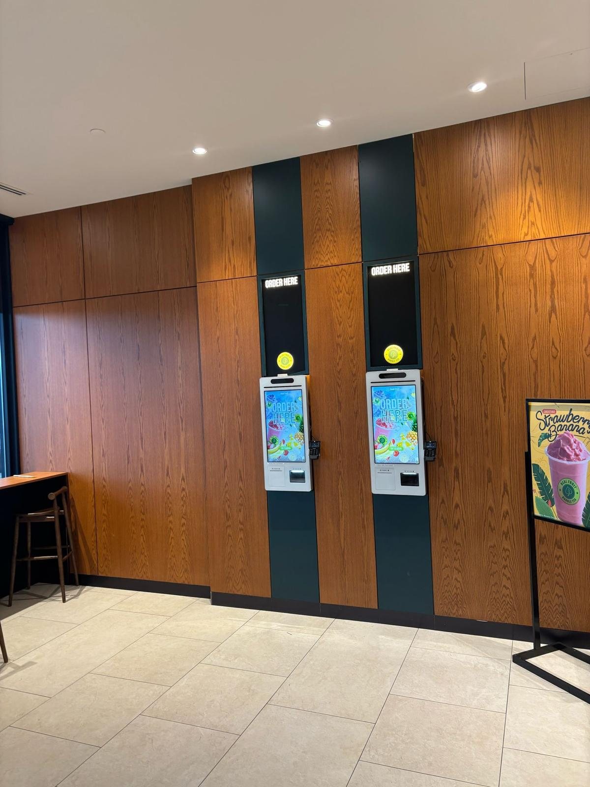 Oak wall panelling with integrated self-order kiosks, commercial millwork