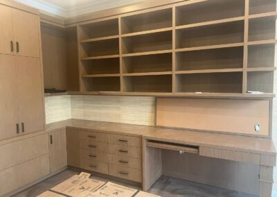 Oak home office built-ins with desk, drawers and open shelving
