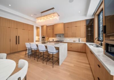 Oak kitchen with a seating island and built-in wall ovens, Toronto