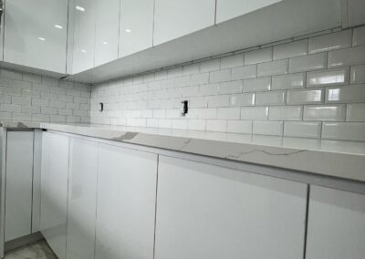 Small-space white kitchen run with subway tile, Toronto