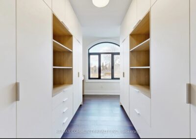 Walk-through closet with full-height doors and oak open shelving, Toronto