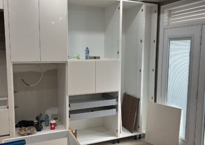 White gloss tall cabinets with walnut accents