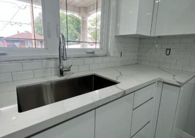 White kitchen cabinets with a subway tile backsplash, Toronto