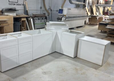 White shaker base cabinets assembled in the Kali shop