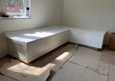 White shaker corner banquette bench with storage