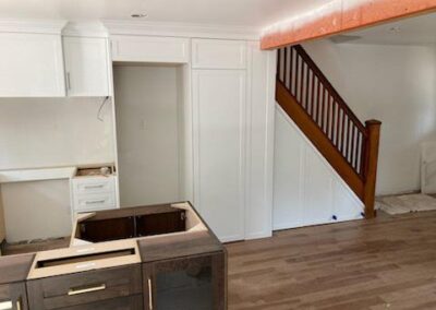 White shaker pantry wall and under-stair storage